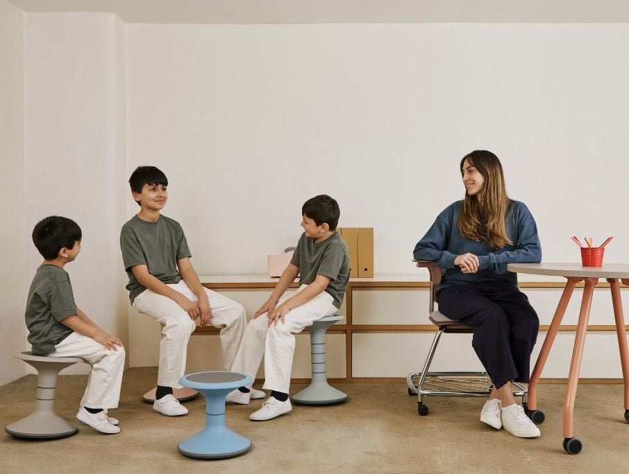 teacher with students in flexible seating arrangement